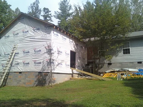 Tyvek wrapped gable on a new room addition beside an existing home in Keller